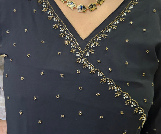 Front pleated Black A line gown with yoke and neck work with antique gold beadsgold cut beads