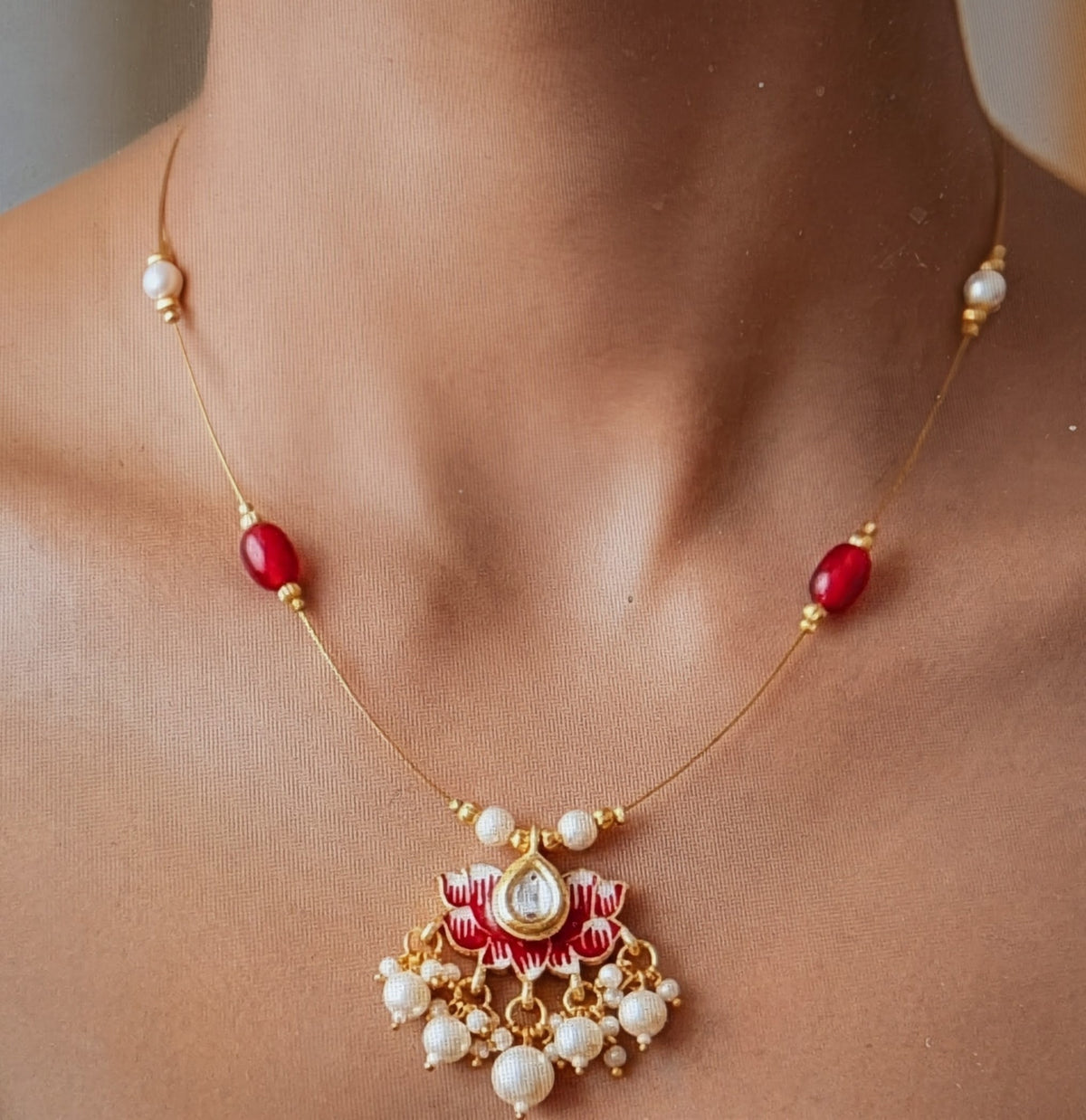 Invisible necklace with red and pearl beads
