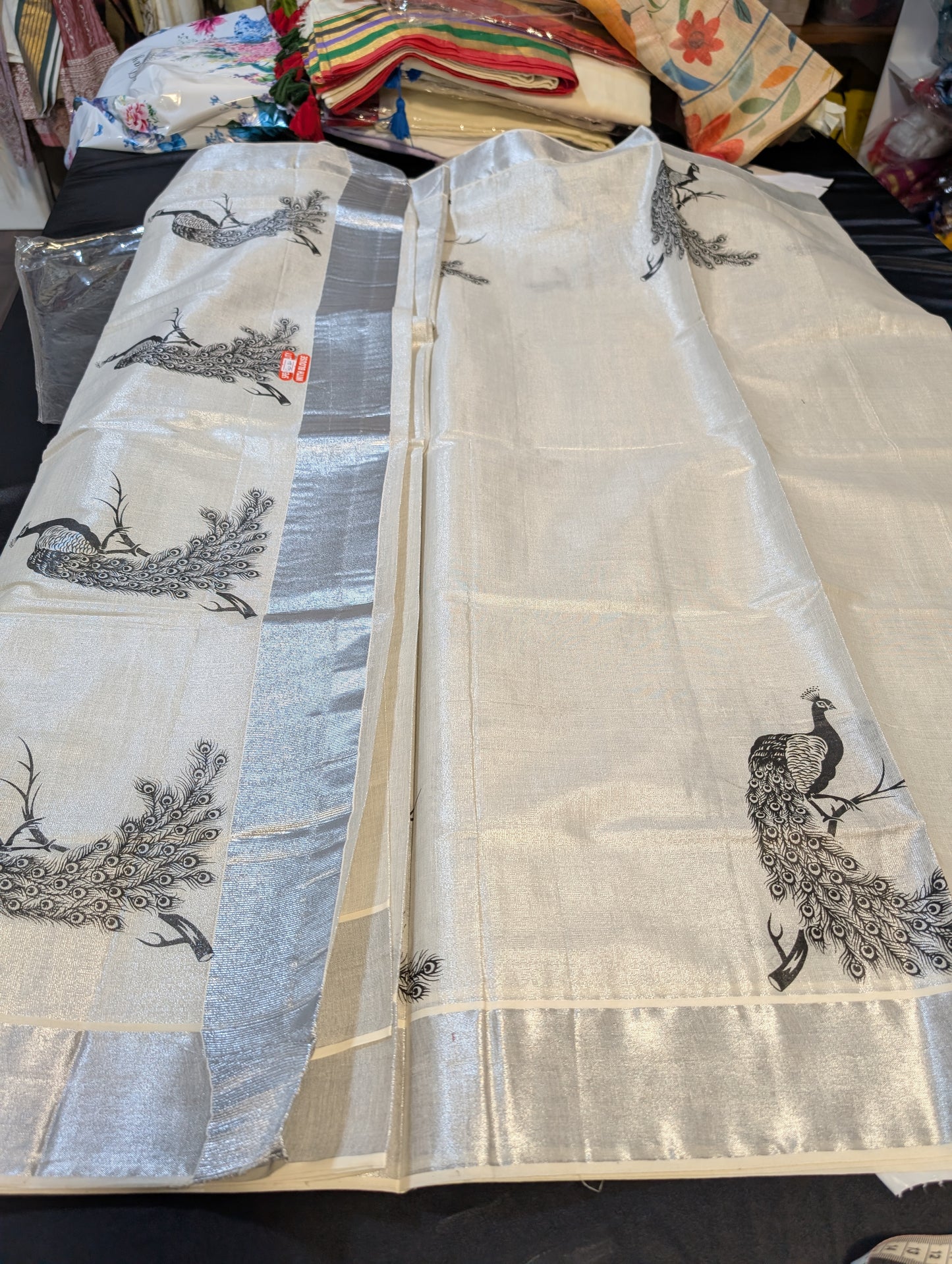 Kerala silver tissue saree with peacock motiffs