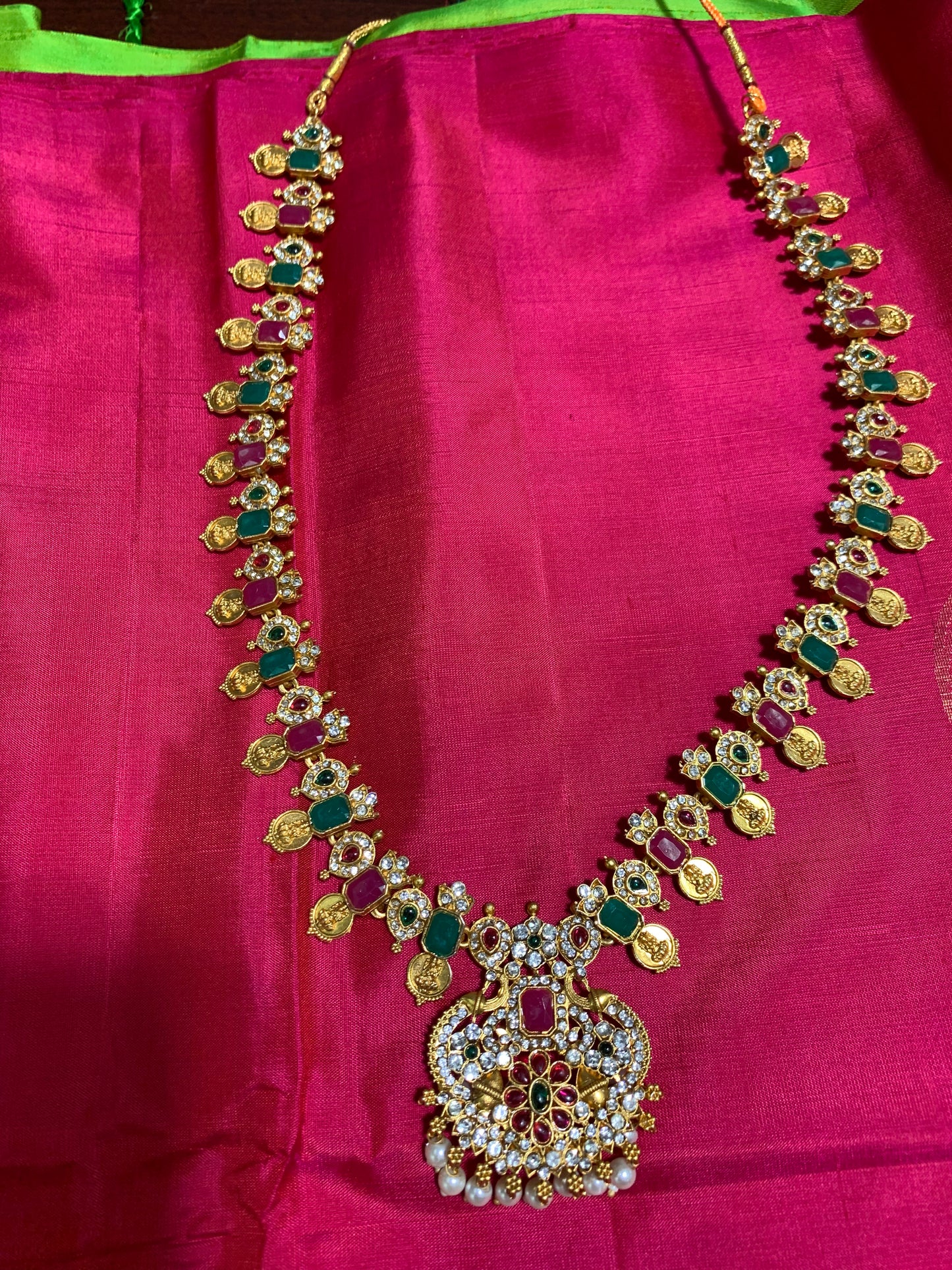 Pink and green stone studded golden necklace