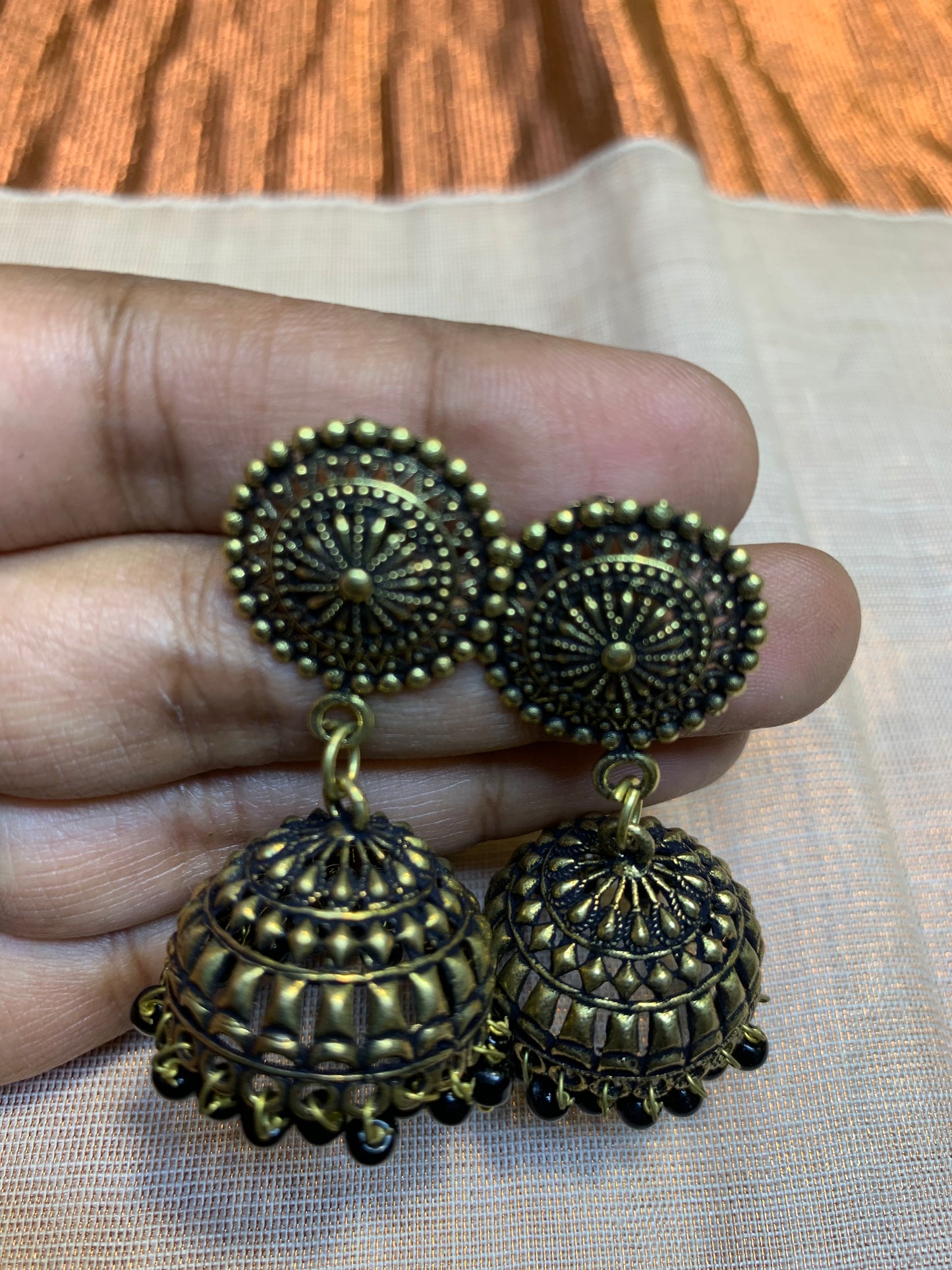 Oxidized golden jhumka earring with black pearls