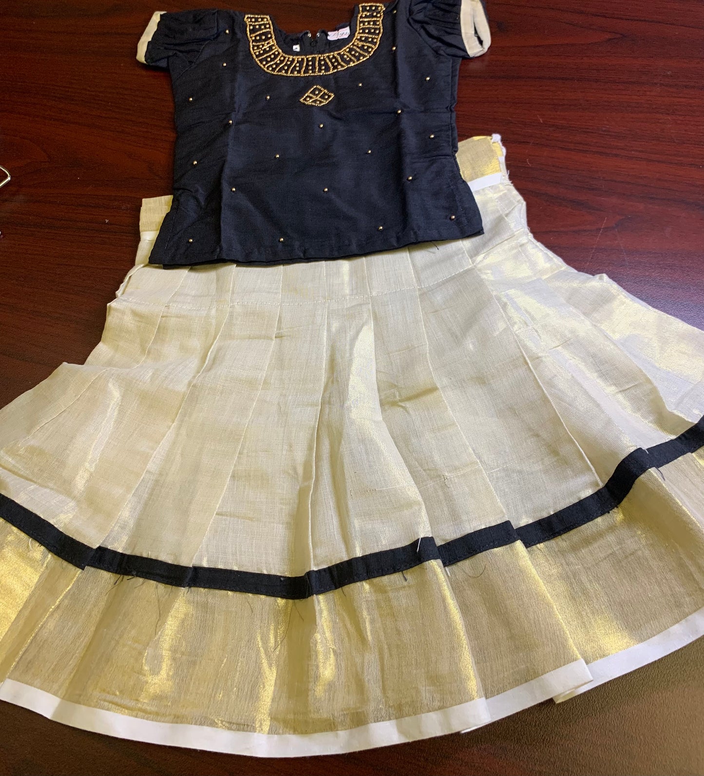 Girls Kerala kasavu skirt with golden border and black blouse