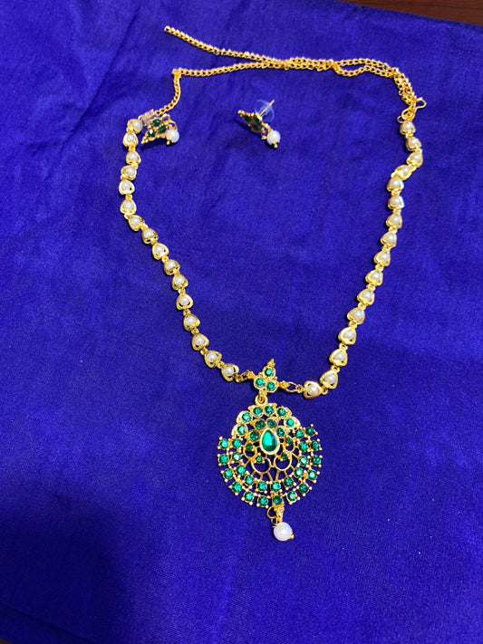 Golden necklace with green stone