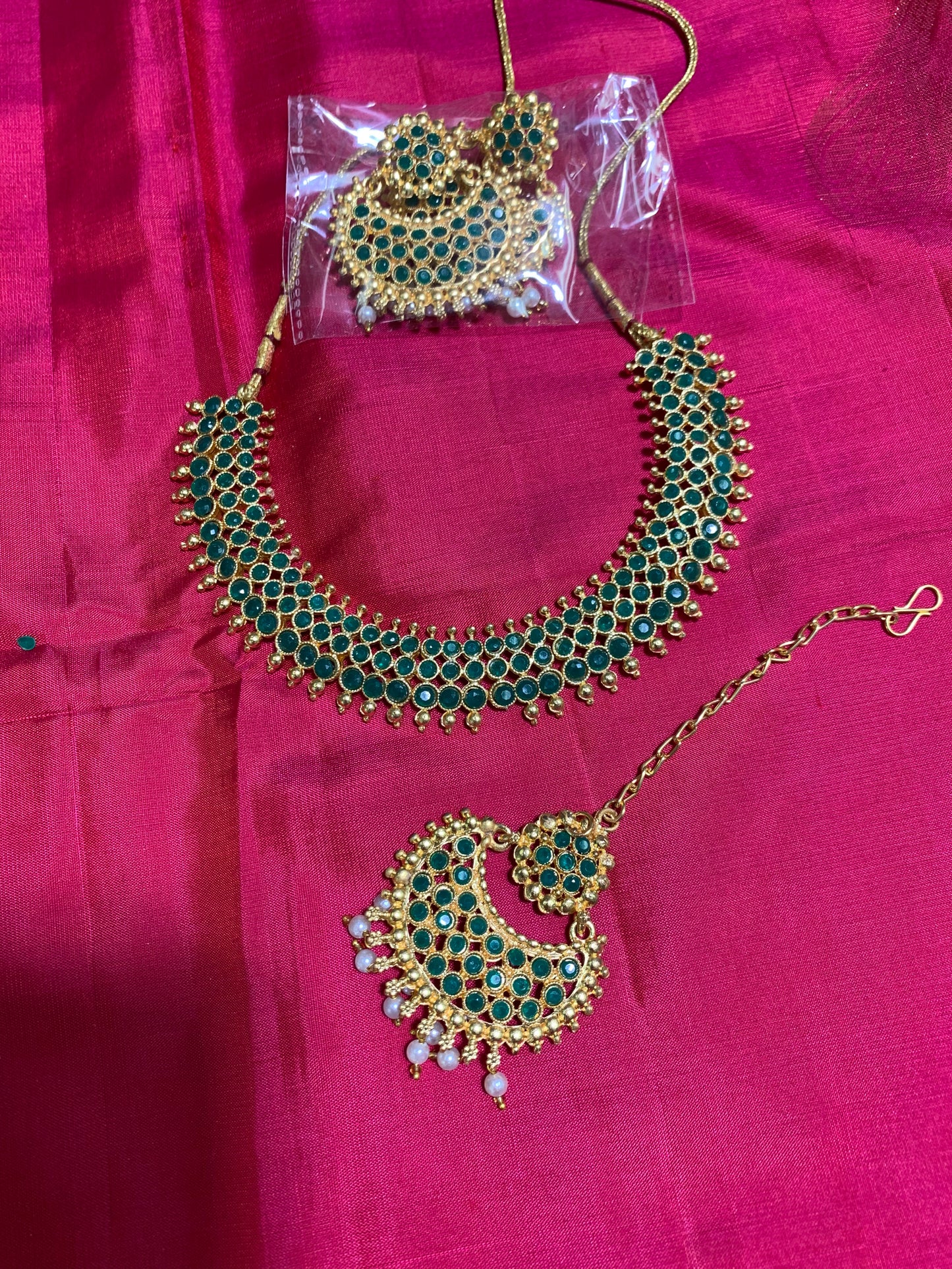 Golden necklace with green stone