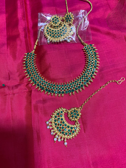 Golden necklace with green stone