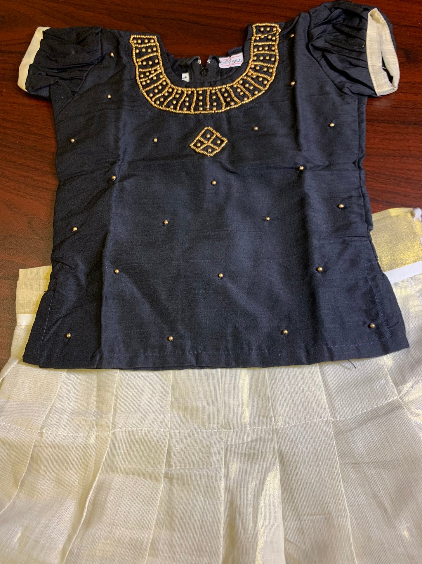 Girls Kerala kasavu skirt with golden border and black blouse