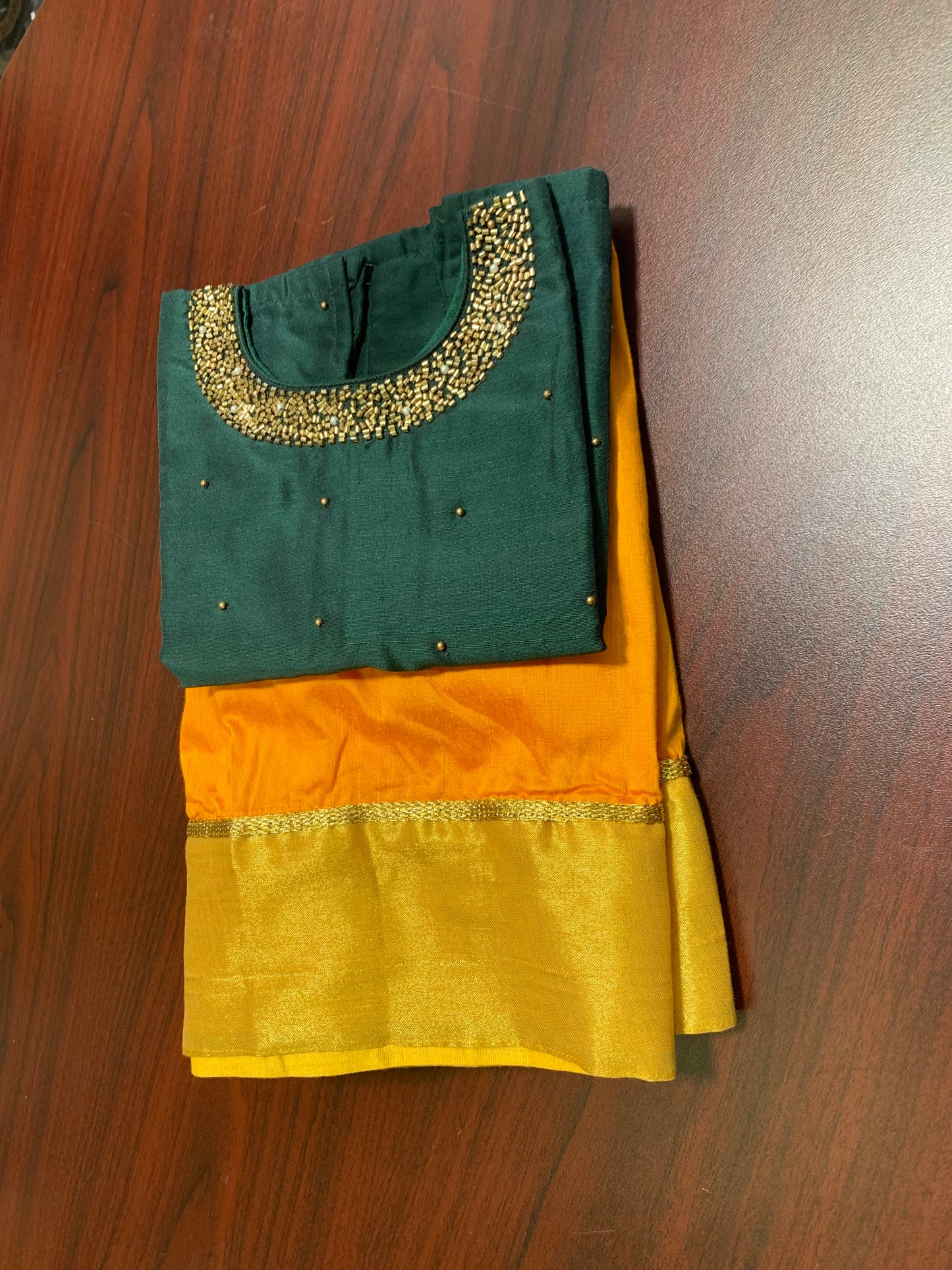 Silk skirt with golden border and dark green beads worked top