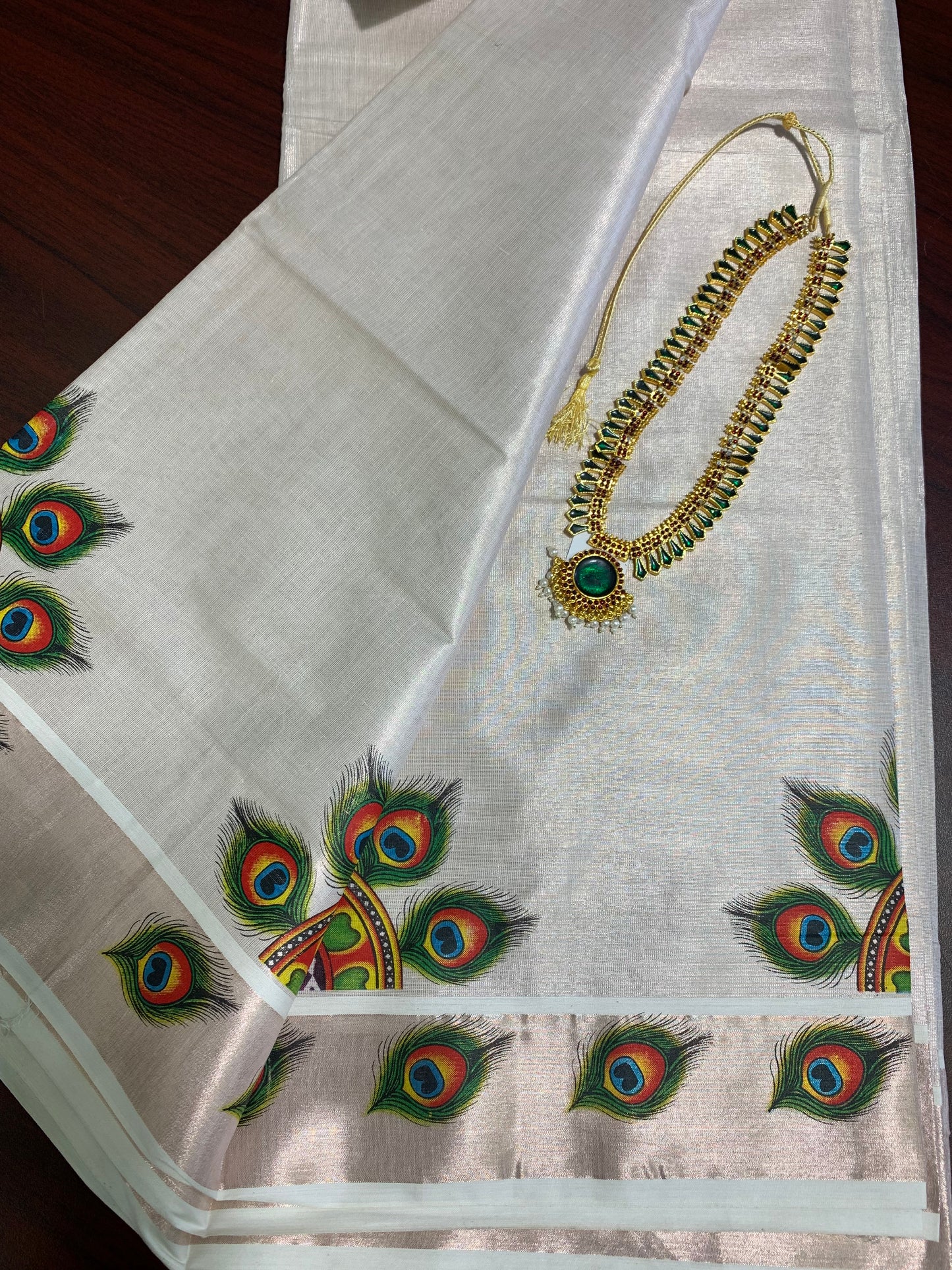 Kerala rose gold tissue saree with peacock feather design