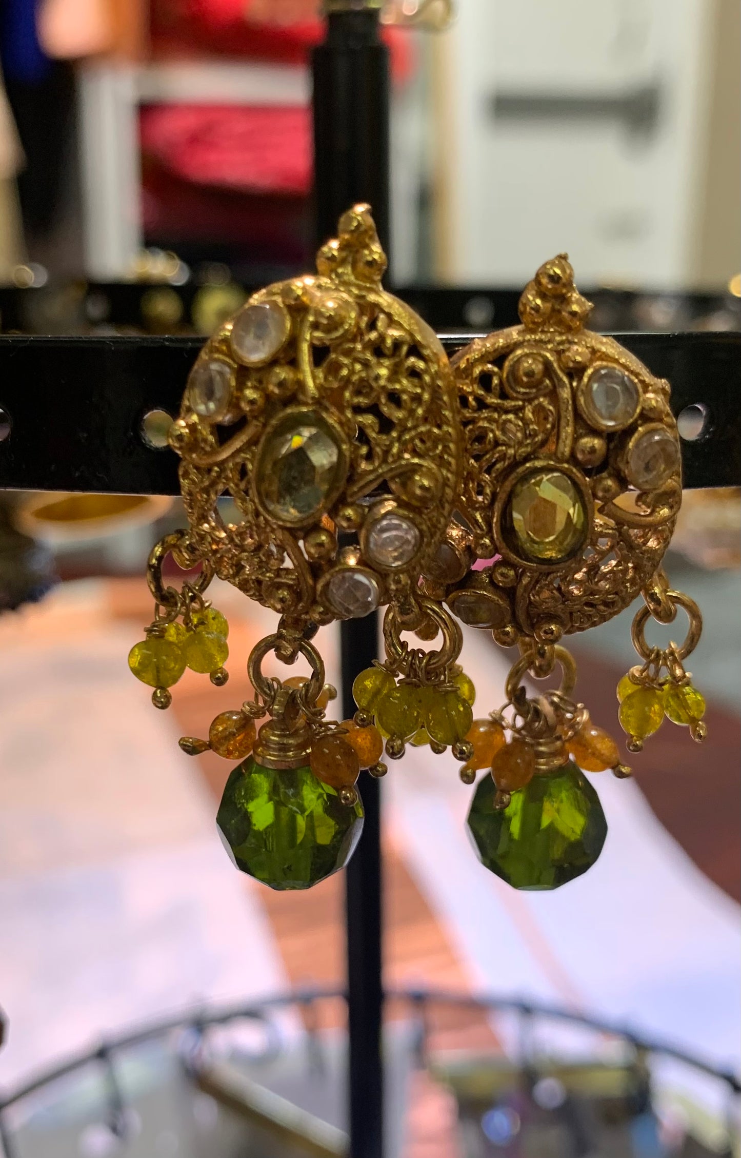 Golden earring with green beads