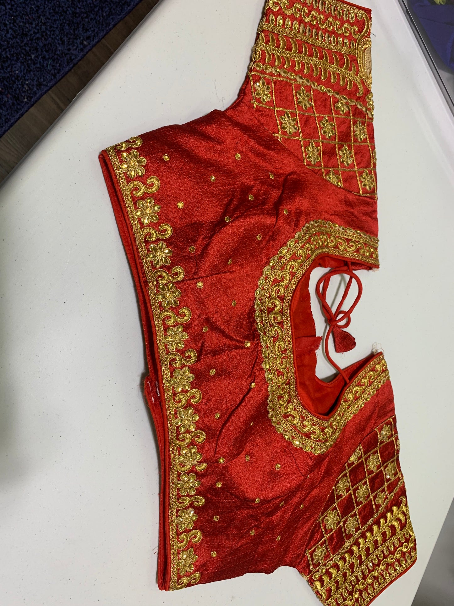 Readymade red blouse with golden embroidery and stone work