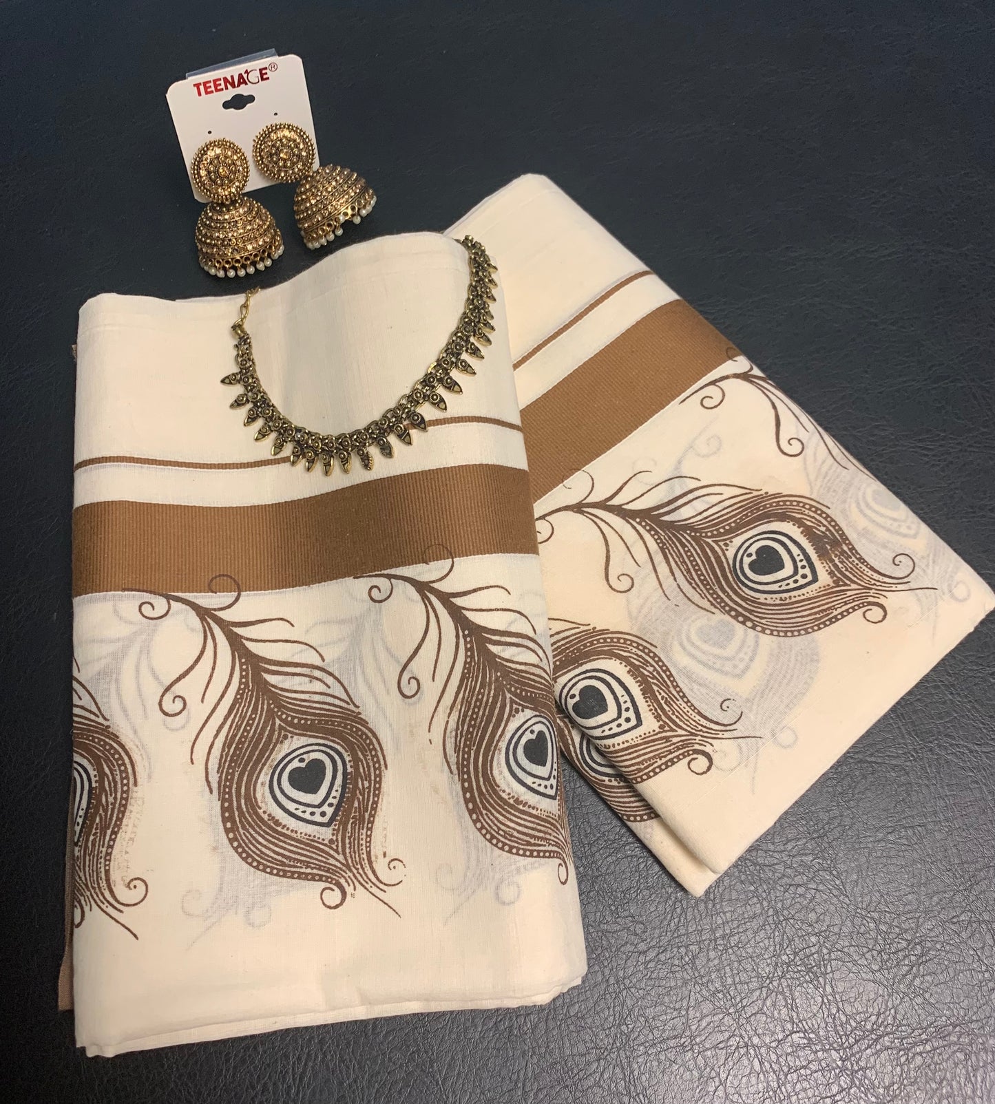 Kerala cotton settumundu with light brown border and peeli design