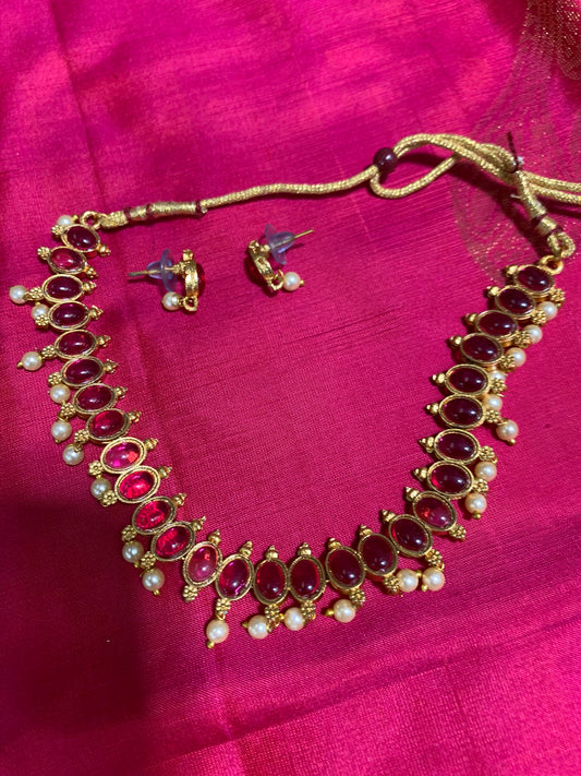 Golden necklace with pink stone