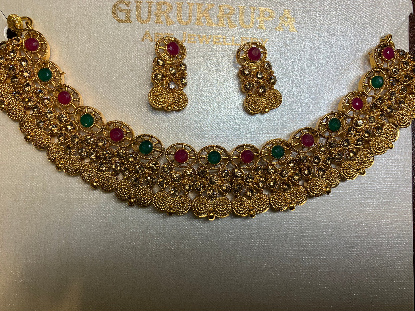 Gold toned red and green stones necklace set