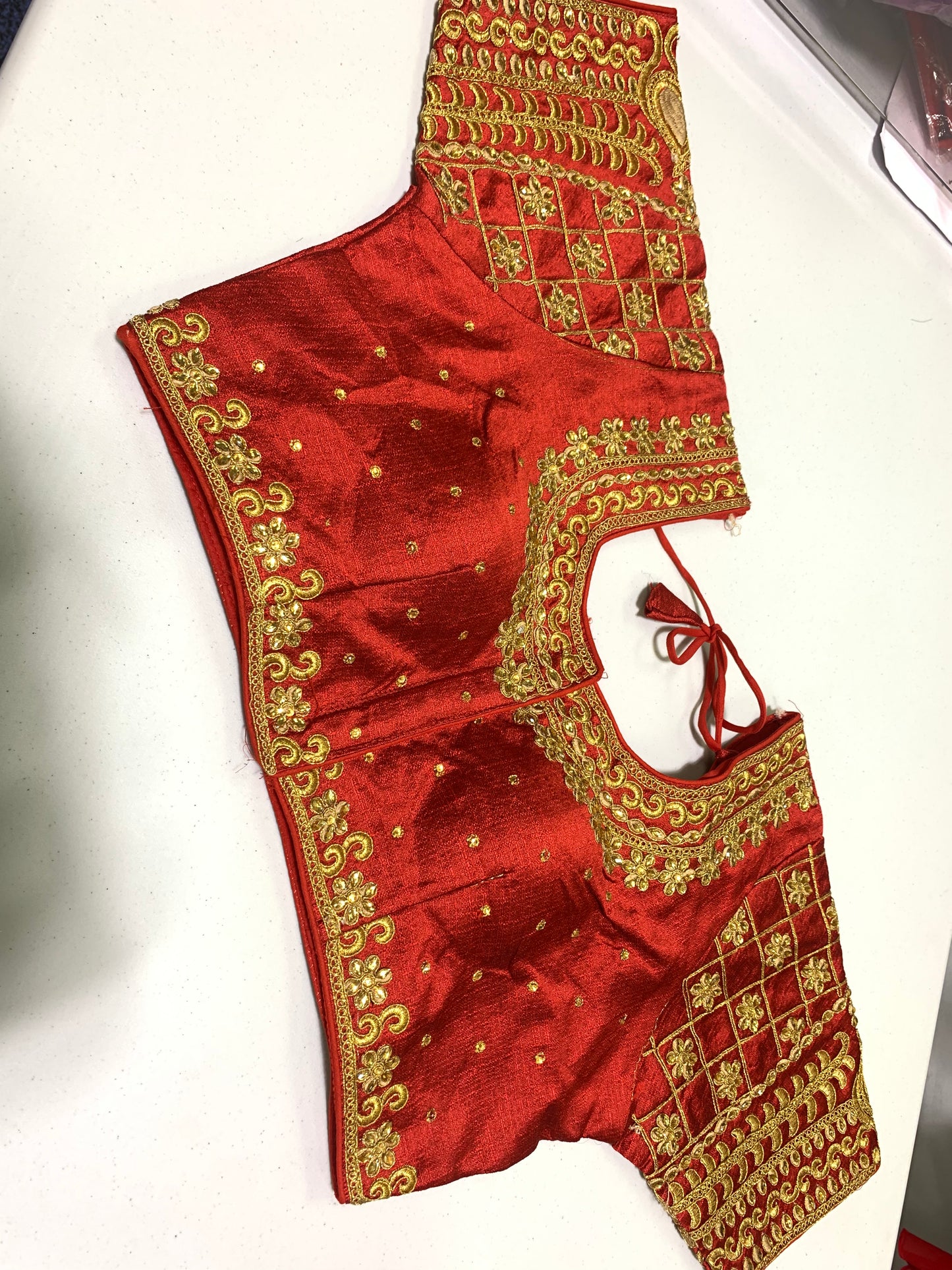 Readymade red blouse with golden embroidery and stone work