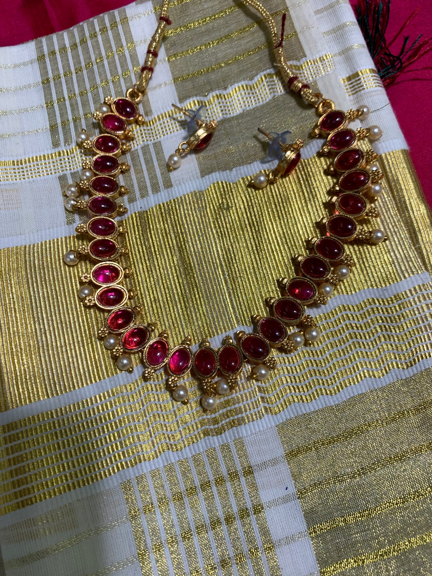 Golden necklace with pink stone