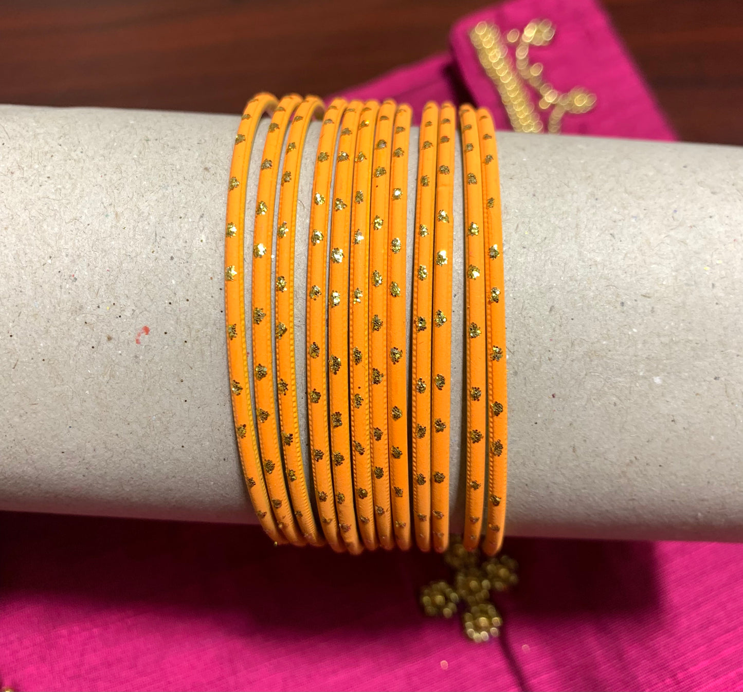 Orange metal bangles with gold spot design