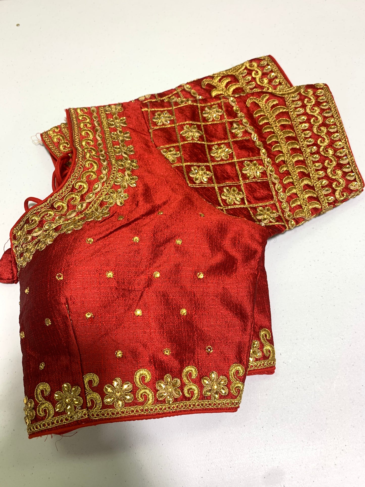 Readymade red blouse with golden embroidery and stone work