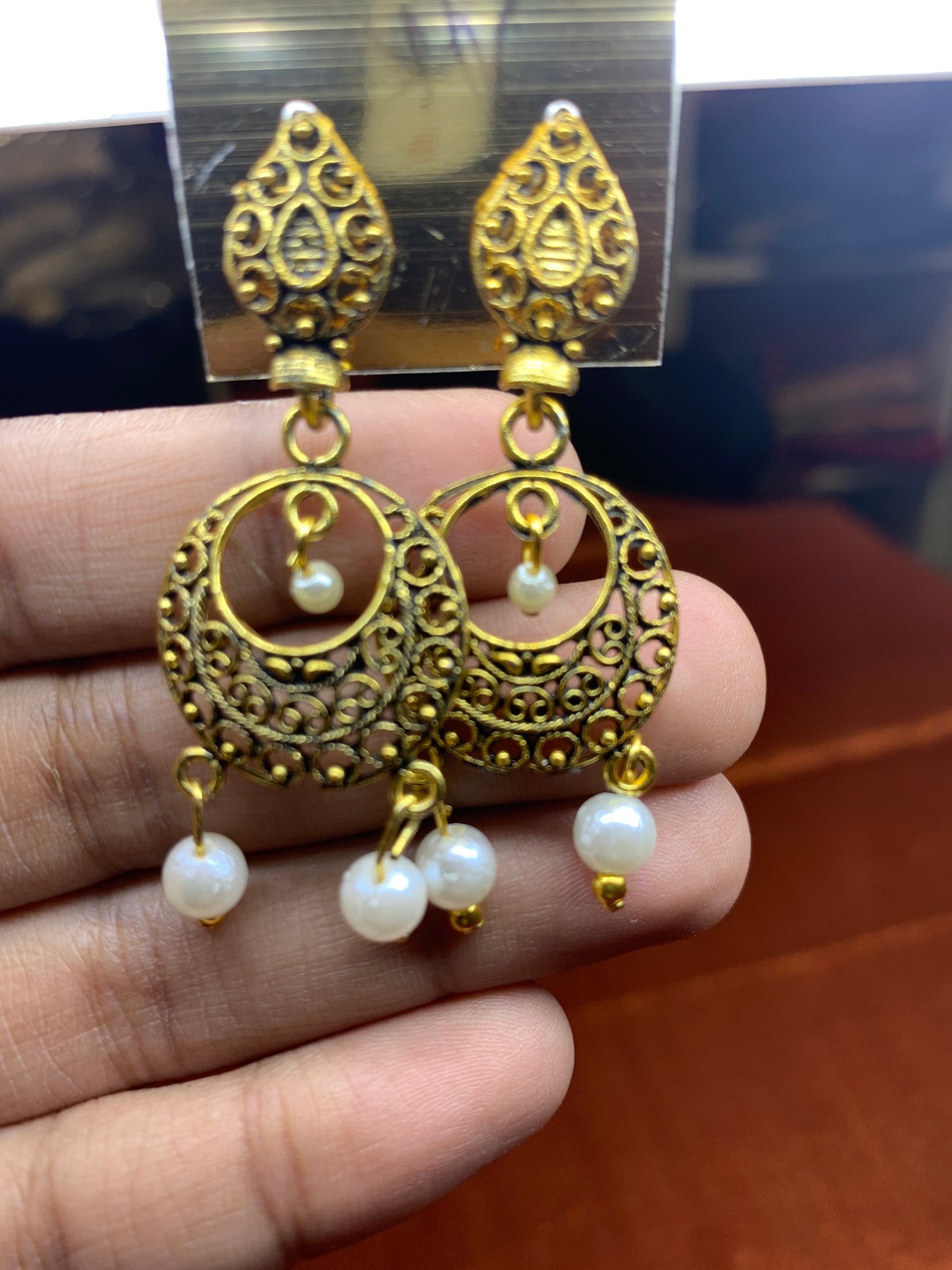 Traditional gold earring with white pearls