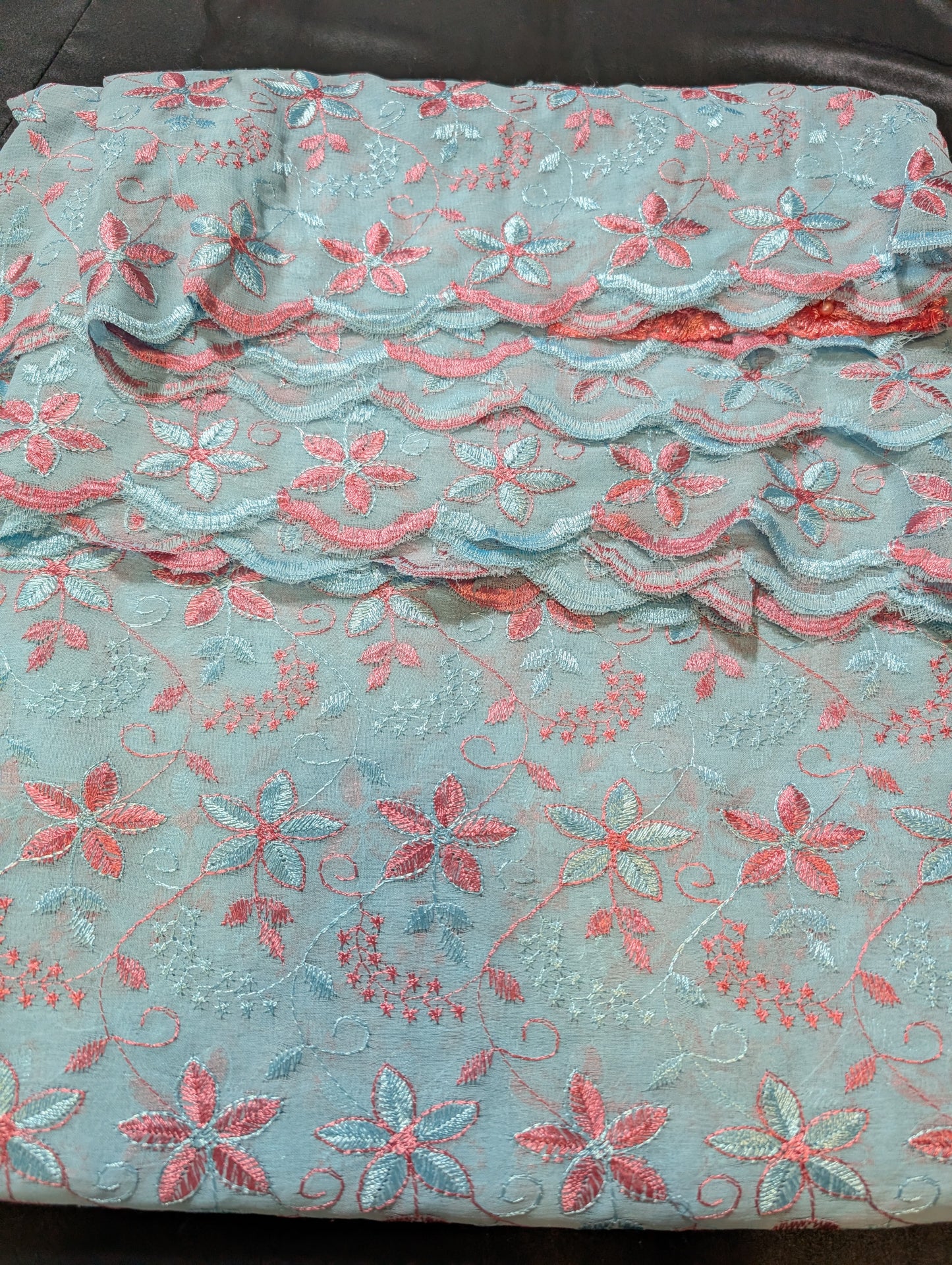 Georgette saree in sky blue colour with dark peach embroidery band scalloped work in borders