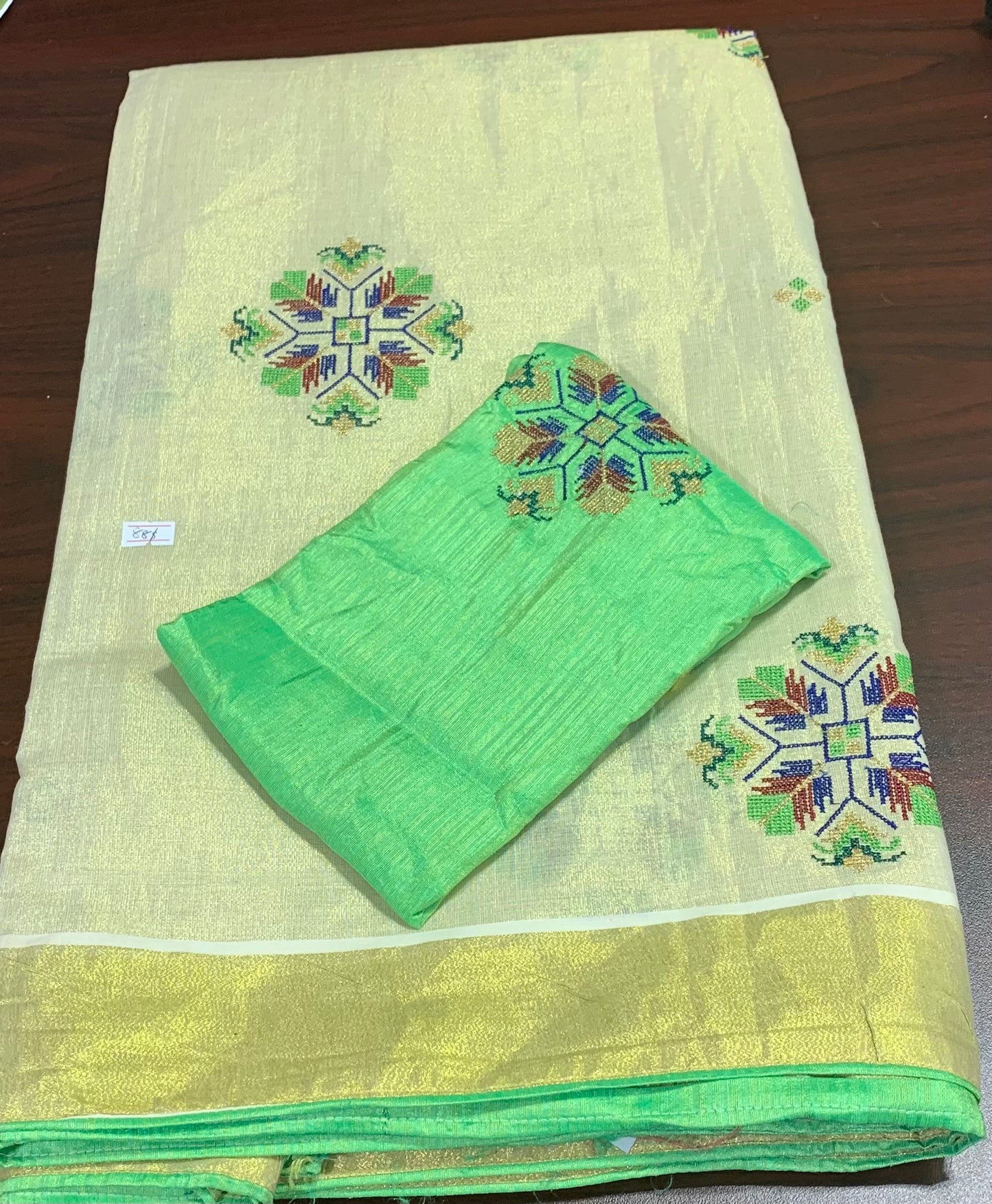 Kerala kasavu settu saree with cross stitch embroidery paired with matching blouse